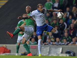 Josh Magennis of Northern Ireland (L) and Vangelis Moras of Greece (R) during the Euro 2016 Group F international football match at Windsor Park on October 8, 2015 in Belfast, Northern Ireland.