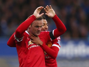 Wayne Rooney of Manchester United celebrates scoring his team's third goal with his team mate Jesse Lingard during the Barclays Premier League match between Everton and Manchester United at Goodison Park on October 17, 2015