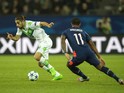PSV Eindhoven's forward Luciano Narsingh (R) and Wolfsburg's Swiss defender Ricardo Rodriguez vie for the ball during the Group B, first-leg UEFA Champions League football match VfL Wolfsburg vs PSV Eindhoven in Wolfsburg, northern Germany on October 21, 