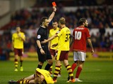 Referee Stuart Attwell sends off Henri Lansbury of Nottingham Forest during the Sky Bet Championship match between Nottingham Forest and Burnley at City Ground on October 20, 2015 in Nottingham, England.