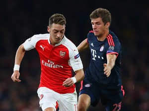 Mesut Oezil of Arsenal is chased by Thomas Mueller of Bayern Munich during the UEFA Champions League Group F match between Arsenal FC and FC Bayern Munchen at Emirates Stadium on October 20, 2015 in London, United Kingdom.
