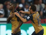 Joel Campbell (L) of Arsenal celebrates scoring his team's third goal with his team mate Santi Cazorla (R) during the Barclays Premier League match between Swansea City and Arsenal at Liberty Stadium on October 31, 2015