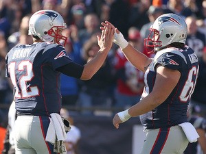Tom Brady #12 of the New England Patriots celebrates a touchdown with David Andrews #60 in the first quarter against the Washington Redskins at Gillette Stadium on November 8, 2015
