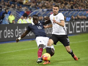 French defender Bacary Sagna (L) vies with Germany's defender Jonas Hector during a friendly international football match between France and Germany ahead of the Euro 2016, on November 13, 2015 at the Stade de France stadium in Saint-Denis, north of Paris