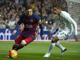 Barcelona's Argentinian forward Lionel Messi (L) vies with Real Madrid's French defender Raphael Varane during the Spanish league 'Clasico' football match Real Madrid CF vs FC Barcelona at the Santiago Bernabeu stadium in Madrid on November 21, 2015.