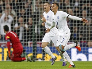 England's midfielder Dele Alli (R) celebrates scoring his team's first goal during the friendly football match between England and France at Wembley Stadium in west London on November 17, 2015