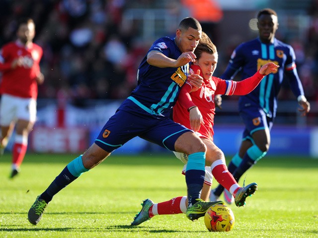 Jake Livermore of Hull City is tackled by Luke Freeman of Bristol City during the Sky Bet Championship match between Bristol City and Hull City at Ashton Gate on November 21, 2015