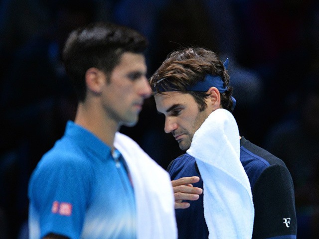 Switzerland's Roger Federer (R) and Serbia's Novak Djokovic are pictured during their men's singles group stage match on day three of the ATP World Tour Finals tennis tournament in London on November 17, 2015