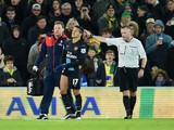 An injured Alexis Sanchez of Arsenal (17) is given assistance during the Barclays Premier League match between Norwich City and Arsenal at Carrow Road on November 29, 2015