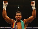 Anthony Joshua celebrates after defeating Dillian Whyte by ko on December 12, 2015