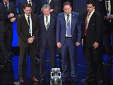Representatives of teams drawn in group B (L-R) Slovakia's assistant coach Stefan Tarkovic, England's coach Roy Hodgson, Russia's coach Leonid Slutski and Wales' coach Chris Coleman pose with the trophy after the final draw of the UEFA Euro 2016 football 