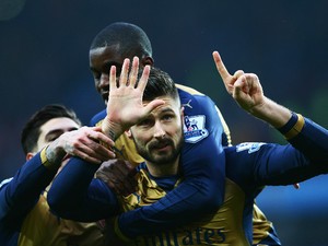 Olivier Giroud of Arsenal celebrates with Joel Campbell as he scores their first goal from a penalty during the Barclays Premier League match between Aston Villa and Arsenal at Villa Park on December 13, 2015 in Birmingham, England.