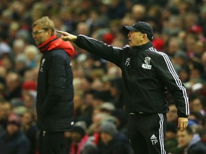 Tony Pulis, manager of West Bromwich Albion points as Jurgen Klopp, manager of Liverpool looks on during the Barclays Premier League match between Liverpool and West Bromwich Albion at Anfield on December 13, 2015 in Liverpool, England.