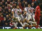 Craig Dawson of West Bromwich Albion (25) celebrates with team mates as he scores their first and equalising goal during the Barclays Premier League match between Liverpool and West Bromwich Albion at Anfield on December 13, 2015 in Liverpool, England.