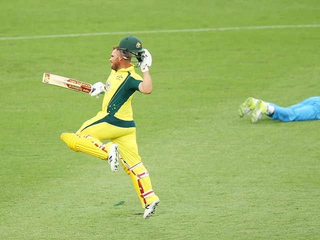 Aaron Finch of Australia celebrates scoring a century against India on January 20, 2016