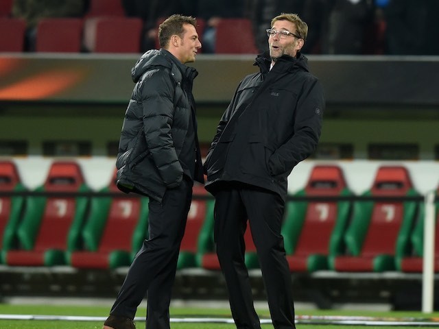 Markus Weinzieri and Jurgen Klopp share a joke during the Europa League game between Augsburg and Liverpool on February 18, 2016