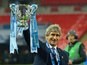 Manuel Pellegrini celebrates with the League Cup trophy on February 28, 2016