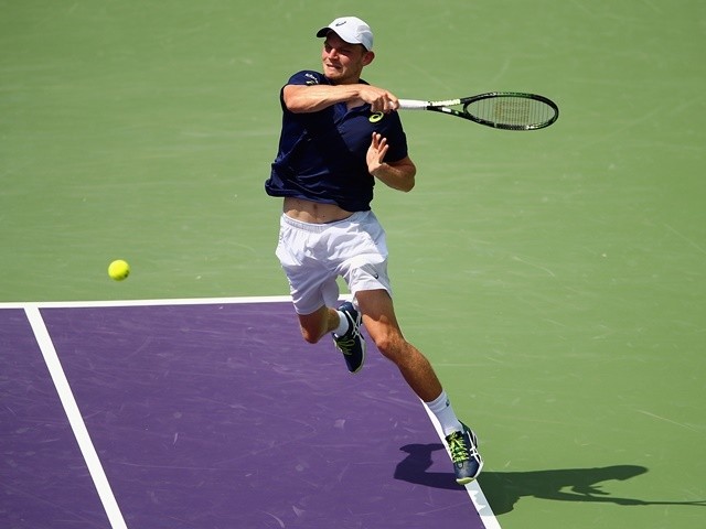 David Goffin plays a forehand against Novak Djokovic in their semi-final during the Miami Open on April 1, 2016 