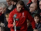 Jordan Henderson arrives on crutches in the stands during the Premier League game between Liverpool and Stoke City on April 10, 2016