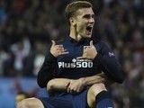 Antoine Griezmann celebrates in the air after scoring the opener during the Champions League quarter-final between Atletico Madrid and Barcelona on April 13, 2016