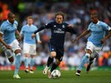 Luka Modric of Real Madrid is flanked by Manchester City pair Fernando and Fernandinho during the Champions League semi-final first leg on April 26, 2016