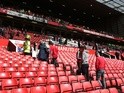 Supporters are evacuated from the abandoned Premier League match between Manchester United and Bournemouth on May 15, 2016