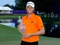 Daniel Berger celebrates with the trophy after winning the FedEx St Jude Classic during the final round at TPC Southwind on June 12, 2016