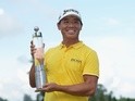 Ashun Wu of China celebrates with the trophy after winning the 2016 Lyoness Open on June 12, 2016