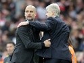 Pep Guardiola distractedly hugs Arsene Wenger after the Premier League match between Arsenal and Manchester City on April 2, 2017