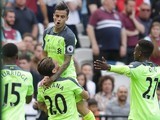 Adam Lallana hoists up Philippe Coutinho after he bags a second during the Premier League game between West Ham United and Liverpool on May 14, 2017