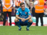 Mesut Ozil sits dejected during the Premier League game between Liverpool and Arsenal on August 27, 2017