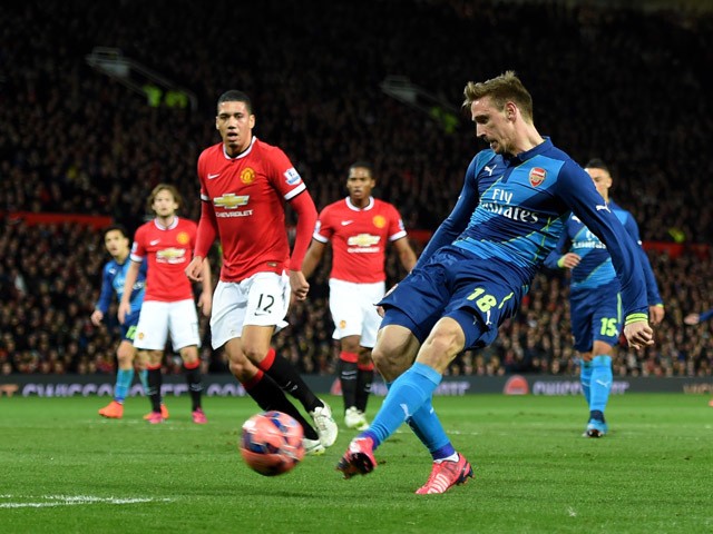 Nacho Monreal of Arsenal celebrates scores the opening goal during the FA Cup Quarter Final match between Manchester United and Arsenal at Old Trafford on March 9, 2015
